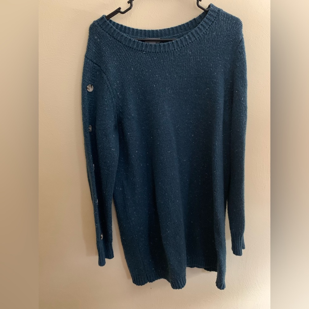 Tunic length sweater with button details down each sleeve.